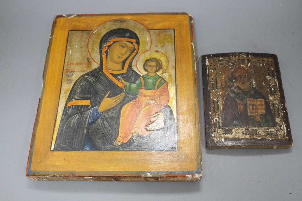 A 19th century Russian tempera on wood icon, 31 x 26cm and another smaller icon, 17.5 x 13cm